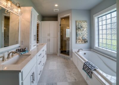 Double vanity and large tub in white master bathroom