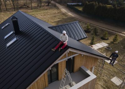 long-shot-man-with-helmet-sitting-roof